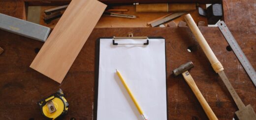 Yellow Pencil on White Paper And Carpentry Tools