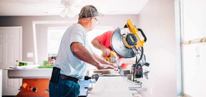 man standing infront of miter saw